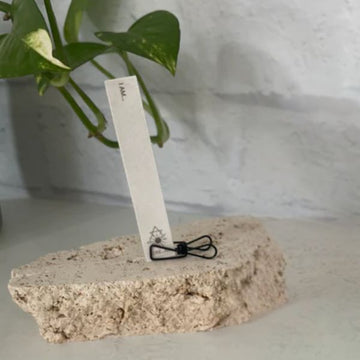 Paper incense strip standing in clip, ready to burn. Features four intention-setting prompts. Ideal for meditation, manifestation, and ritual use. Clean-burning and 100% natural.